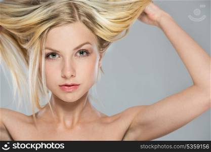 Portrait of blond girl rising up hair