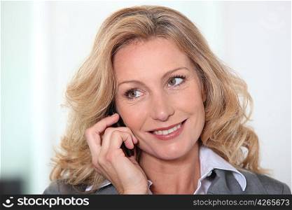 Portrait of blond mature woman having phone call