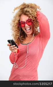 Portrait of blond woman listening to music player