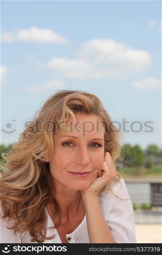 Portrait of blond woman outdoors on a sunny day