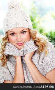 Portrait of blond woman wearing wool sweater and hat