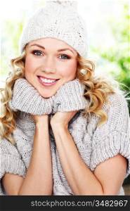 Portrait of blond woman wearing wool sweater and hat