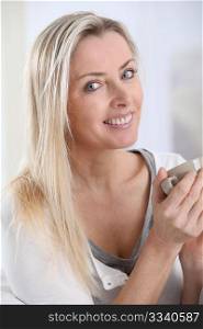 Portrait of blond woman with cup of tea