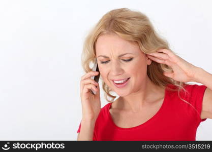 Portrait of blond woman with red shirt using mobile phone