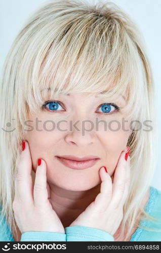 Portrait of blond woman with sapphirine eyes