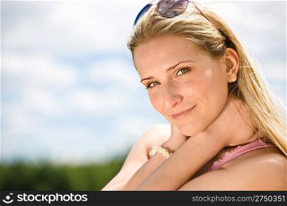 Portrait of blond woman with summer sky in nature