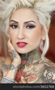 Portrait of blond woman with tattoos