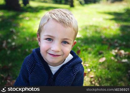 Portrait of blonde boy looking at camera smiling
