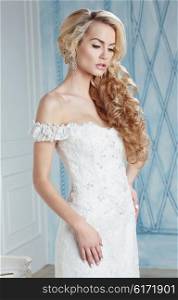 Portrait of blonde bride in the interior. Long hair, delicate makeup.