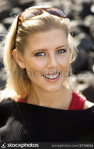 Portrait of blonde Caucasian mid-adult woman smiling and looking at viewer.