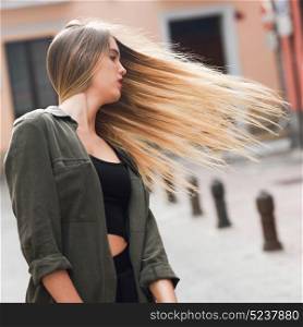 Portrait of blonde girl moving her amazing long hair
