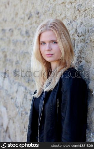 Portrait of blonde girl outdoor looking at camera