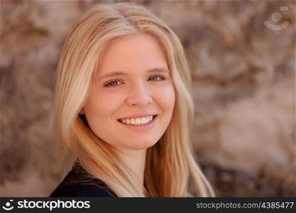 Portrait of blonde girl outdoor looking at camera