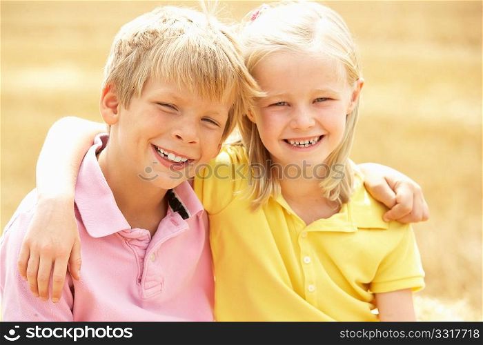 Portrait Of Boy And Girl In Summer Harvested Field