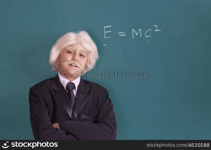 Portrait of boy dressed as Einstein with maths equation