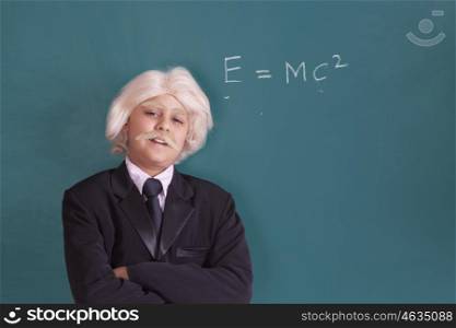 Portrait of boy dressed as Einstein with maths equation