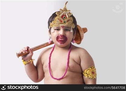 Portrait of boy dressed as God Hanuman against white background