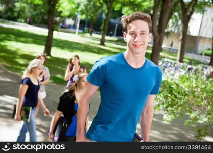 Portrait of boy going college with friends in background