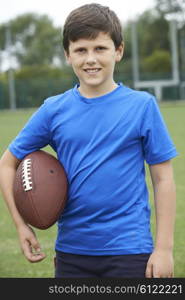 Portrait Of Boy Holding Ball On School Football Pitch