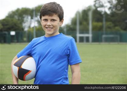 Portrait Of Boy Holding Ball On School Rugby Pitch