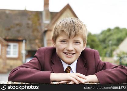 Portrait Of Boy In Uniform Outside School Building