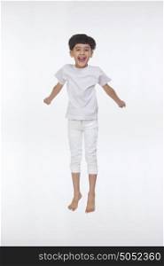 Portrait of boy jumping in the air