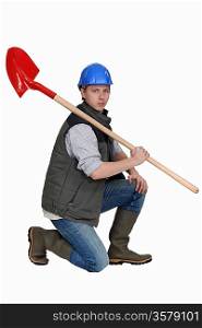 portrait of bricklayer holding shovel