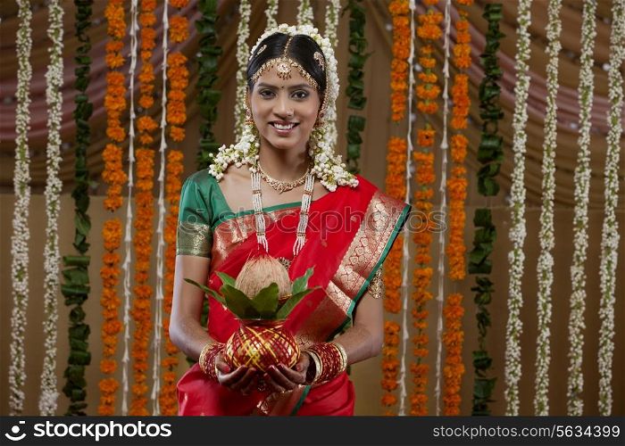 Portrait of bride holding kalash