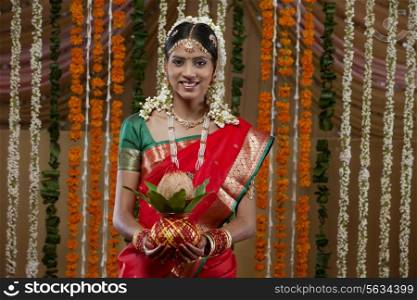 Portrait of bride holding kalash