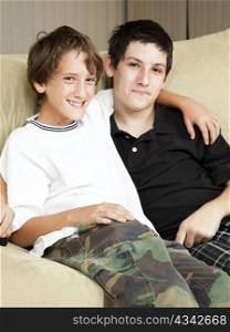 Portrait of brothers - a teenage boy with acne and a younger boy.