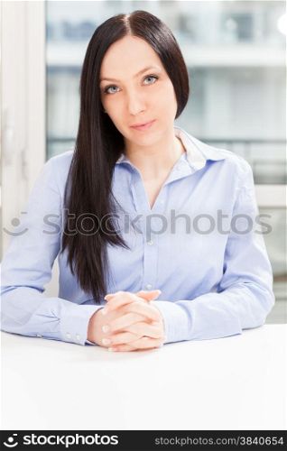 Portrait of brunette businesswoman sitting in the office