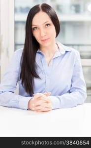 Portrait of brunette businesswoman sitting in the office