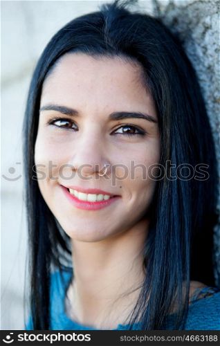 Portrait of brunette cool girl with a piercing in her nose