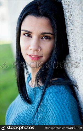 Portrait of brunette cool girl with a piercing in her nose