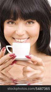 portrait of brunette woman with cup of coffee in water