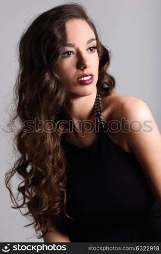 Portrait of brunette woman with long hair wearing black t-shirt