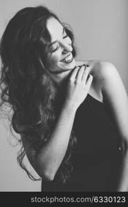 Portrait of brunette woman with long hair wearing black t-shirt