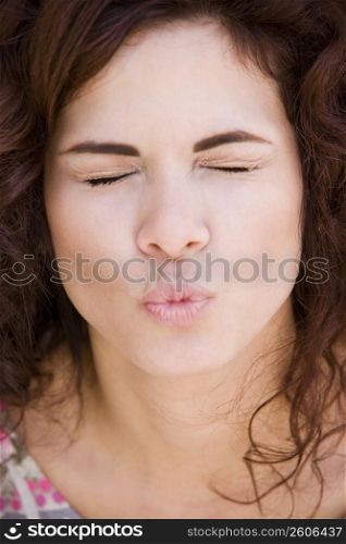 Portrait of brunette young woman kissing