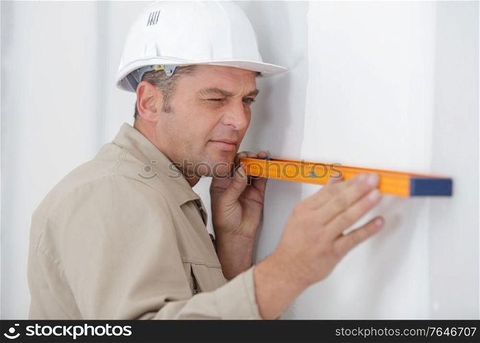 portrait of builder man working with spirit level