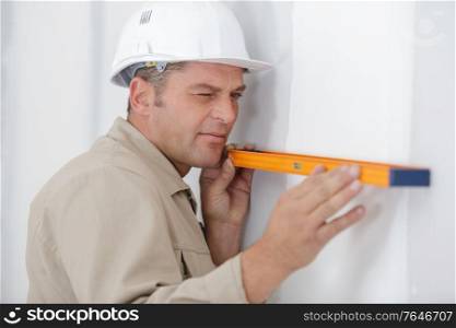 portrait of builder man working with spirit level
