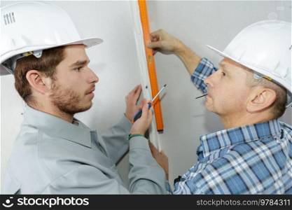 portrait of builder men with level