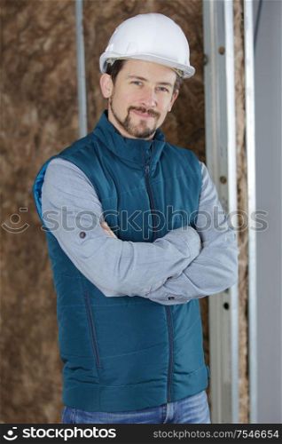 portrait of builder standing indoors