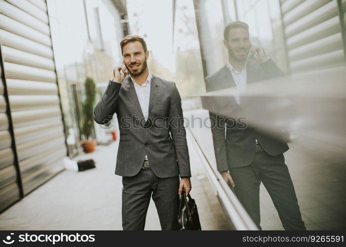 Portrait of businassman uses mobile phone outdoor