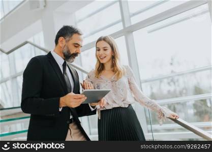 Portrait of business couple with digital tablet in office