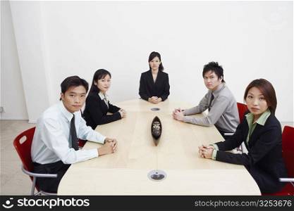 Portrait of business executives sitting in a board room