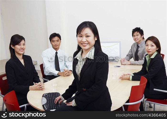 Portrait of business executives sitting in a board room