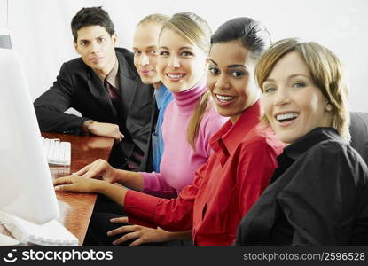 Portrait of business executives sitting in front of a computer