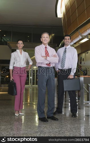 Portrait of business executives standing at an airport