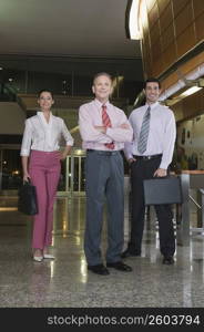 Portrait of business executives standing at an airport