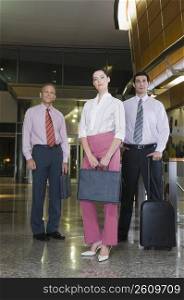 Portrait of business executives standing at an airport